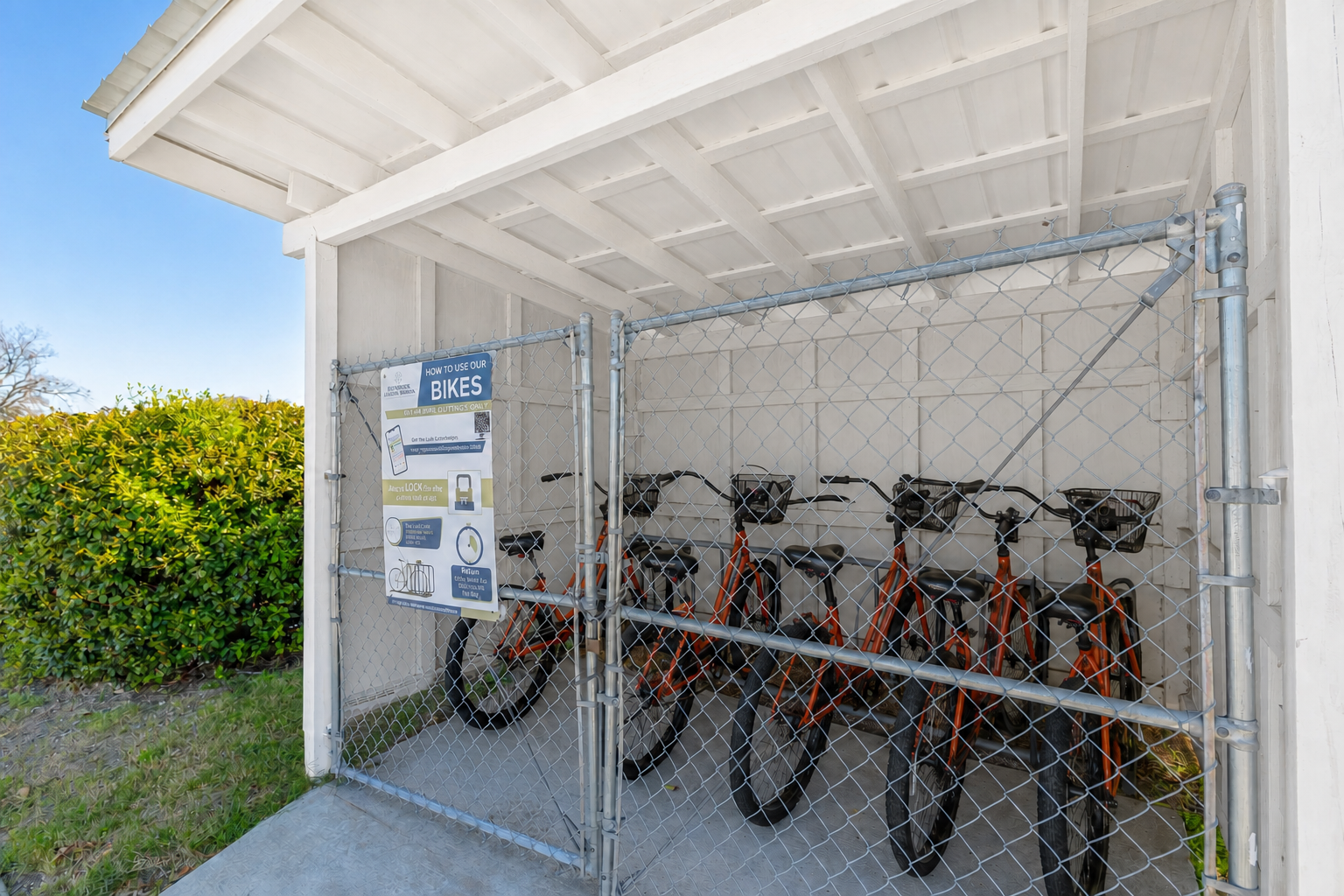 A full rack of complimentary orange Brunswick Landing Marina loaner bicycles ready for marina guests