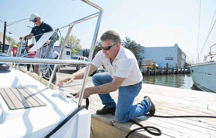 Marina staff assisting with a boat at the dock
